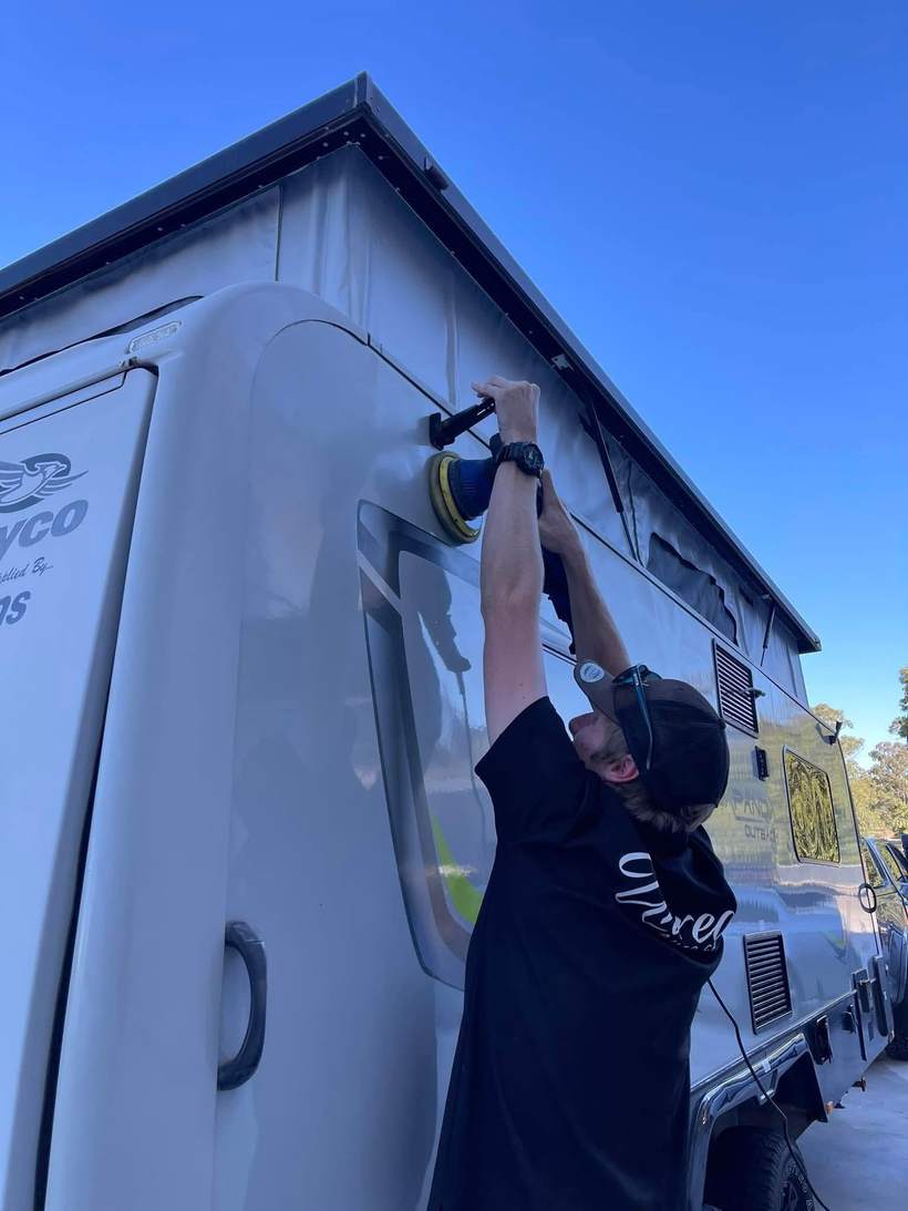 Technician machine polishing a caravan