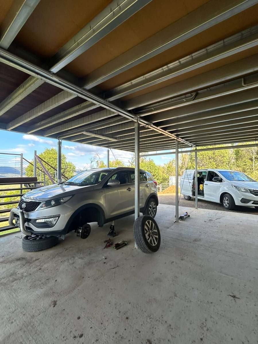 Wheels off a Kia Sportage during a brake and tyre job